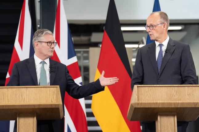STEVENAGE, ENGLAND - JULY 17: Britain's Prime Minister Sir Keir Starmer and German Chancellor Friedrich Merz hold a press conference during a visit to the Airbus factory on July 17, 2025 in Stevenage, United Kingdom. German Chancellor Friedrich Merz is making his first visit to the UK since taking office in May, as he and Prime Minister Keir Starmer meet to finalise a bilateral cooperation treaty that will target smuggling gangs and boost defence ties. (Photo by Stefan Rousseau - WPA Pool/Getty Images)