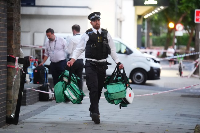 A police officer removes medical bags from the scene in Long Lane, Southwark, south London, where four people were stabbed earlier today. A 58-year-old man died at the scene while three other men were taken to hospital, where one aged 27 has since died. Picture date: Monday July 28, 2025. PA Photo. Photo credit should read: James Manning/PA Wire