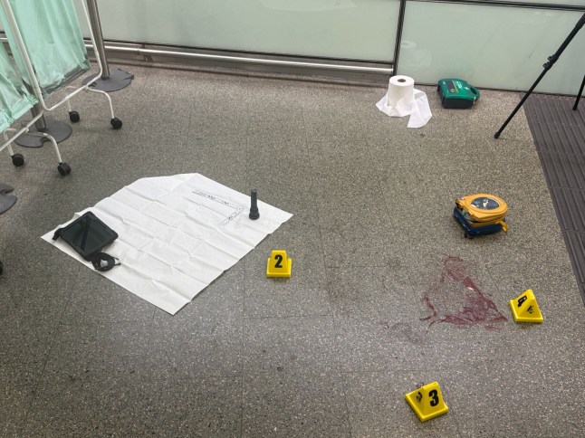 A pool of blood has formed at the top of an escalator down into St Pancras
