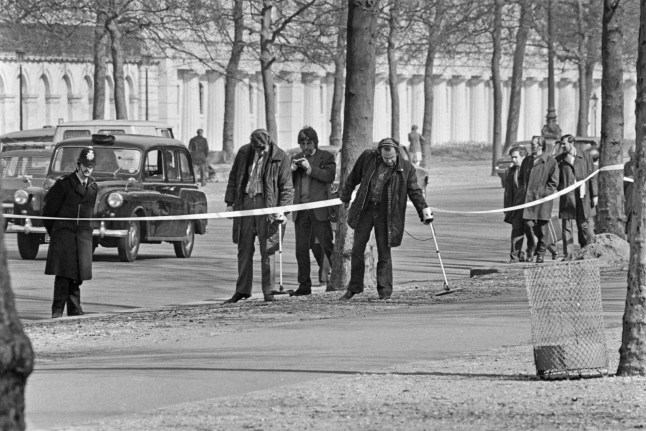 Police searching the Mall for bullets near Buckingham Palace in London, after an attempt was made to kidnap Princess Anne, the Princess Royal, a few days earlier, London, UK, 23rd March 1974. The Princess and her husband Mark Phillips were threatened by 26-year-old Ian Ball, and shots were fired, injuring Anne's protection officer Inspector James Beaton. (Photo by David Cairns/Express/Hulton Archive/Getty Images)