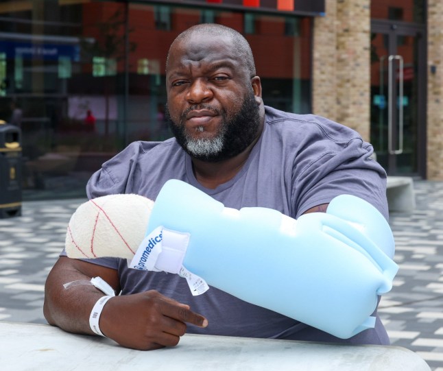 Manhunt Launched for Samurai Sword Attacker After Brutal Car Park Stabbing in Canary Wharf A manhunt is underway after a former Westminster Rugby player was viciously attacked with a samurai sword in a shocking ambush at a Canary Wharf car park on Saturday night (2 August). Alexander Ogbechie, 45, from West London, was on his way to meet friends for a cigar at Boisdale???s in Cabot Square when he was set upon from behind by a man wielding a large blade. The attack occurred in the Cabot Square underground car park just before 9.30pm. Recalling the horrifying moment, Alexander said: ???He came up behind me and was aiming for my heart. Fortunately, I turned around just in time and saw him. I managed to move, but the sword went through my arms and side.??? Despite his injuries, Alexander remained conscious as emergency services rushed to the scene. London Ambulance Service paramedics were on-site within four minutes. A London Ambulance Service spokesperson said: ???We were called at 9.28pm on Saturday, 2 August, to reports of a stabbing at Cabot Square, E14. We sent resources to the scene, including an ambulance crew, an incident response officer, and a paramedic in a fast response car. We also dispatched a trauma team in a car from London???s Air Ambulance. ???Our first paramedics arrived in four minutes. We treated a man at the scene for serious injuries and took him to a major trauma centre.??? Alexander was taken to Royal London Hospital in Whitechapel, where he underwent emergency surgery to repair severed nerves, muscles, and tendons. He remains in a serious but stable condition. The suspect fled the scene immediately after the attack. Detectives are scouring CCTV footage from Cabot Square and surrounding areas as part of a fast-paced investigation. A Metropolitan Police spokesperson said: ???Police were called by London Ambulance Service at 21:29hrs on Saturday, 2 August, to reports of a stabbing in a car park at Cabot Square, Canary Wharf. ???Officer