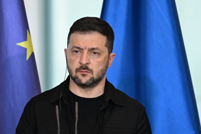 Ukrainian President Volodymyr Zelensky looks on during a joint press conference with the German Chancellor after a video conference of European leaders with the US President on the Ukraine war ahead of a summit between the US and Russian leaders, in Berlin, on August 13, 2025. European leaders held online talks with US President Trump, hoping to convince him to respect Ukraine's interests when he discusses the war with Putin in Alaska on August 15. (Photo by RALF HIRSCHBERGER / AFP) (Photo by RALF HIRSCHBERGER/AFP via Getty Images)