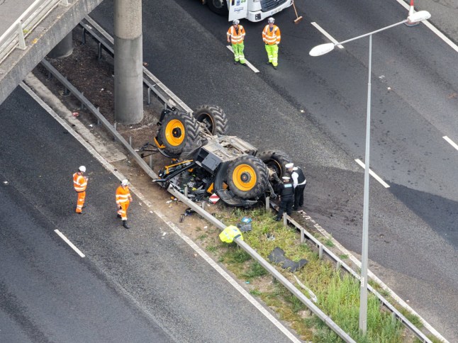 default A man has been airlifted to hospital with serious injuries after a tractor fell off a bridge and on to the central reservation of the M20 in Kent following a crash. Kent Police said it was called at about 11:15 BST on Monday to a two-vehicle crash on the A227 overbridge near Wrotham. Part of the M20 was closed in both directions shortly before midday and at 12:40 National Highways said the road was shut in both directions between junction three, near Addington, and junction one, near Swanley. Photo released 18/08/2025