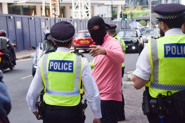 Mandatory Credit: Photo by Vuk Valcic/ZUMA Press Wire/Shutterstock (15464753ac) Masked counter-protesters are held back by police officers as protesters gather in support of migrants outside Britannia International Hotel in Canary Wharf where asylum seekers are housed, part of ongoing migrant-related demonstrations taking place across the UK. Protest In Support Of Migrants Outside Britannia Hotel In Canary Wharf, London, England, United Kingdom - 31 Aug 2025