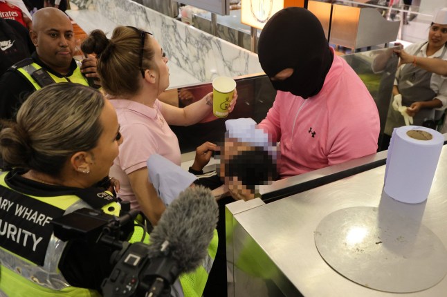 ??George Cracknell Wright 31/08/2025 London, United Kingdom Anti Migrant Hotel protest Canary Wharf A masked man tends to a child who was caught in pepper spray as anti migrant protestors clashed with police in the Canary Wharf shopping centre during an anti migrant demonstration in east London. A officer deployed pepper spray and an arrest was made .The hotel has been the site of multiple protests and continues to house asylum seekers. Photo Credit: George Cracknell Wright