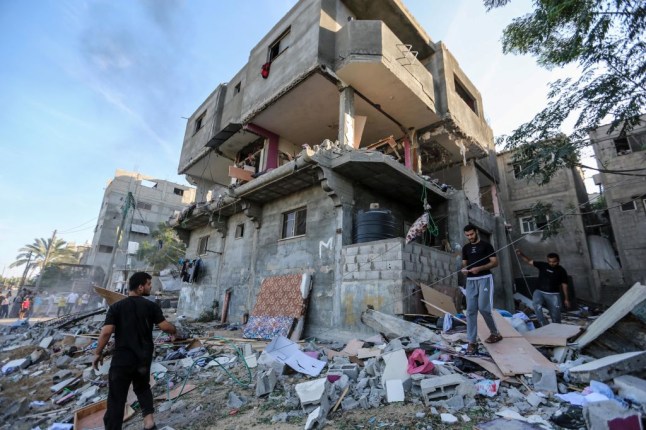 Derelict building and belonging and debris litter the ground in Gaza