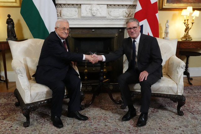 Britain's Prime Minister Keir Starmer (R) shakes hands with Palestinian president Mahmud Abbas (L) at the beginning of their meeting at 10 Downing Street in London
