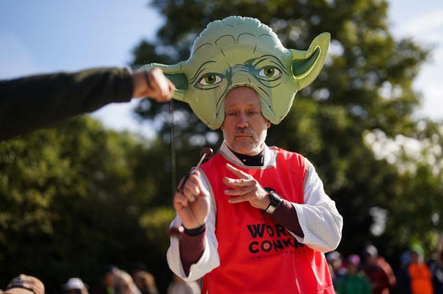 A competitor wearing Star Wars themed Yoda costume take part in the annual World Conker Championships at the Shuckburgh Arms in Southwick, Peterborough. Picture date: Sunday October 13, 2024. PA Photo. Photo credit should read: Jacob King/PA Wire