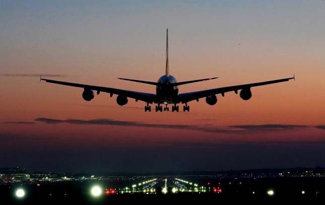 An Emirates Airbus A380 coming in to land at London Gatwick Airport as the sun rises over Crawley, West Sussex.