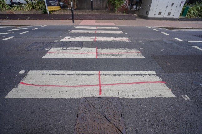 Mandatory Credit: Photo by Amer Ghazzal/Shutterstock (15456958h) A zebra crossing is painted to create a England flag. St George's during a protest against migrants housed at the Britannia hotel in Canary Wharf, Tower Hamlets Anti migrant protest, Canary Wharf, London, United Kingdom - 26 Aug 2025