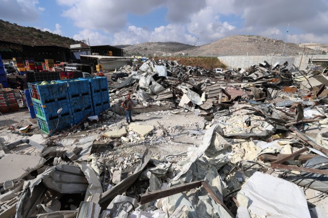 epa12361675 Palestinians inspect the damage to their shops in the central vegetable market in Beita, south of Nablus in the West Bank, 08 September 2025. According to the Palestinian news agency Wafa, Israeli forces demolished shops in the market on Monday morning. EPA/ALAA BADARNEH