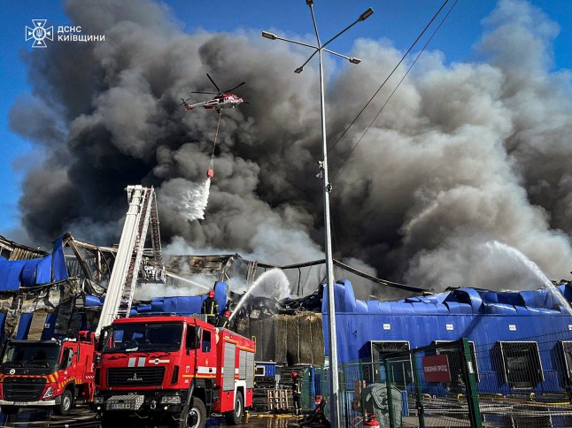 epa12382179 A handout photo made available by the Ukrainian State Emergency Service shows Ukrainian rescuers working at the site of a Russian drone strike on a warehouse belonging to a trading network of construction trade shops near Kyiv, Ukraine, early 16 September 2025, amid the Russian invasion. No deaths or injuries were reported after the overnight Russian attack in the Kyiv area, according to the State Emergency Service of Ukraine. EPA/STATE EMERGENCY SERVICE OF UKRAINE HANDOUT HANDOUT EDITORIAL USE ONLY/NO SALES