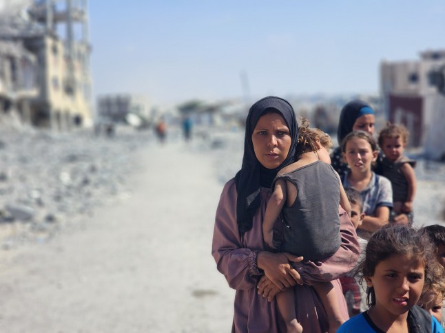 KHAN YUNIS, GAZA - SEPTEMBER 17: Palestinian families forced to flee Gaza City due to Israeli attacks sit on roads, searching for shelter in the al-Mawasi area of Khan Yunis, Gaza, on September 17, 2025. (Photo by Hani Alshaer/Anadolu via Getty Images)