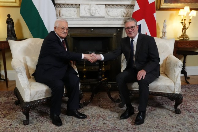 (FILES) Britain's Prime Minister Keir Starmer (R) shakes hands with Palestinian president Mahmud Abbas (L) at the beginning of their meeting at 10 Downing Street in London on September 8, 2025. Britain on Sunday, September 21, has recognised a Palestinian state with a landmark announcement due from Prime Minister Keir Starmer, as several nations were poised to follow at UN talks to pressure Israel over the Gaza war. (Photo by Jonathan Brady / POOL / AFP) (Photo by JONATHAN BRADY/POOL/AFP via Getty Images)