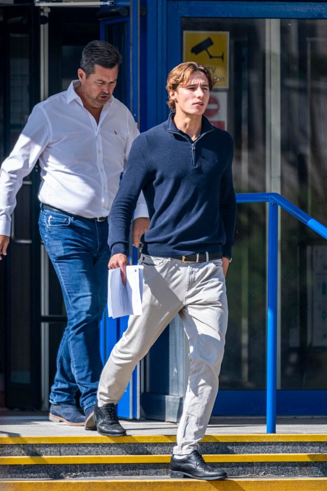 BNPS.co.uk (01202 558833) Pic: BNPS Pictured: Henry Taylor (right) leaving Poole Magistrates Court. Two brothers have appeared in court charged with causing serious injury to a teenage girl during a high speed 'chase' on the millionaire's row of Sandbanks. Henry and Harrison Taylor are alleged to have been on a loop around the exclusive peninsula in Poole Harbour in a BMW 135i and a Mercedes when they crashed. Mia Savage, who was a front seat passenger in the Mercedes, suffered serious injuries in the collision that happened at 1am on Boxing Day 2023.
