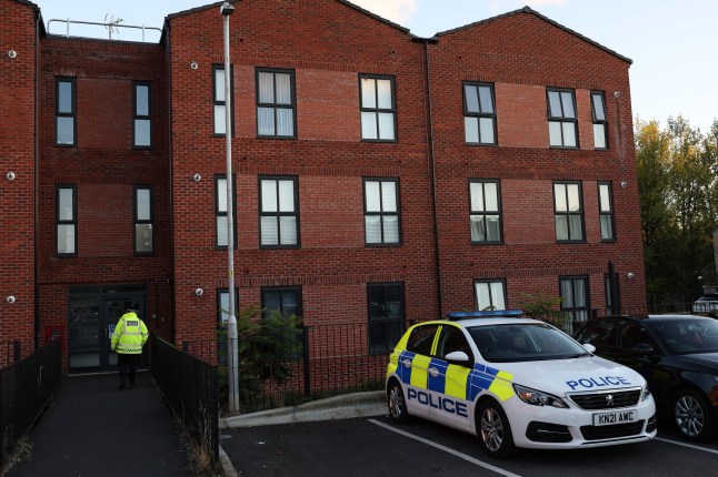 United Kingdom, Ashton Under Lyne 22 September 2025: A police officer stands guard outside a block of flats on Whalley Close in Ashton-Under-Lyne, Greater Manchester after the body of a missing 17 year old girl was found in the early hours of this morning. A 55 year old man has been arrested for her murder and remains in custody. Credit: Ryan Jenkinson / Story Picture Agency