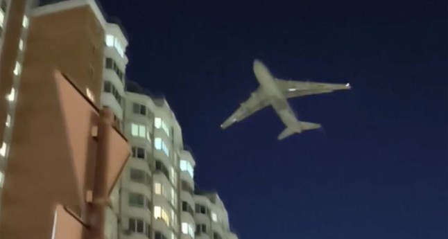 A dramatic flyover as a giant An-124 Ruslan plane - one of the world???s largest cargo aircraft- was forced to skim tower rooftops in Moscow escaping a Ukrainian kamikaze drone attack