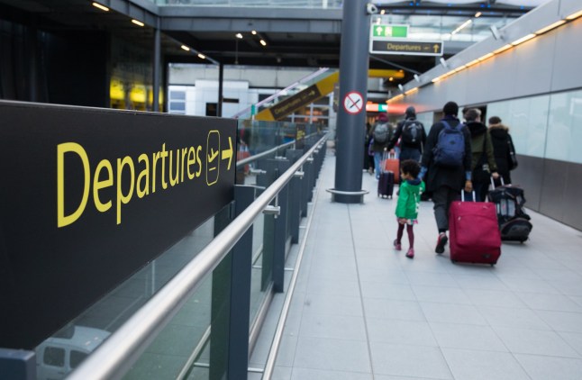 Passengers pull luggage after disembarking an inter-terminal train at London Gatwick Airport Ltd. in Crawley, U.K., on Saturday, Dec. 19, 2020. The pandemic has put a third of all tourism jobs at risk, and airlines around the world have said they need as much as $200 billion in bailouts. Photographer: Chris Ratcliffe/Bloomberg via Getty Images