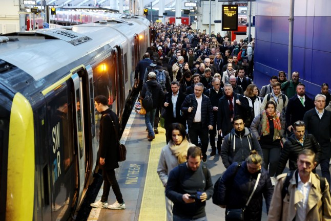 A platform full of passengers disembarking a South Western Railway train at Waterloo station in London.