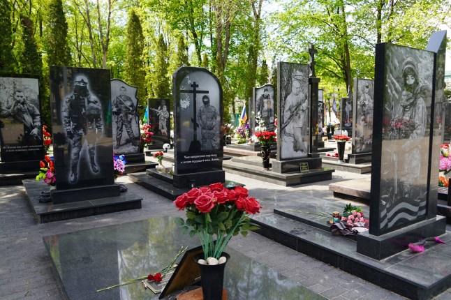 A cemetery filled with the graves of soldiers who have died since 2022 in the war in Ukraine lies opposite a patriotic youth club in Kursk, Russia on April 23, 2025. (Photo by Francesca Ebel/The Washington Post via Getty Images)