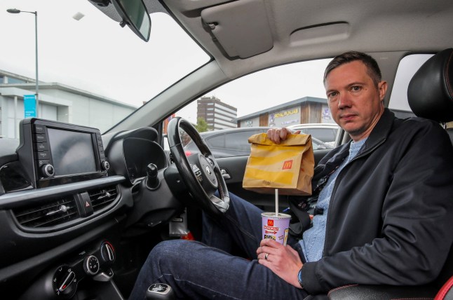 Ed Chatterton at McDonalds in Walsall, West Mids, where he was fined for taking too long to eat his dinner in his car. October 8, 2025. // A McDonald's diner has been threatened with legal action after getting a parking fine of almost ??200 for taking longer than 20 minutes to eat his meal at a drive-thru. Ed Chatterton, 42, was slapped with the hefty bill for eating his ??7.19 Chicken Selects meal too slowly at the branch in Walsall, West Mids., on July 25. He's now been threatened with court proceedings despite receiving no notification of the fine in the post - until debt collectors got in touch last week. The letter from a debt recovery company said the original fine of ??60 had now risen to ??170 and he now faced possible legal action for failing to pay. The married dad-of-two said he didn't realise there were restrictions in place which means there is only 20 minutes free parking at the branch. And he says it took him a good 10-15 minutes to get through the busy drive-thru giving him around five or ten minutes to eat his meal in his car. Ed was also left shocked to only learn of the fine when debt collection firm Trace wrote to him to say he now owed almost ??200 for staying 14 minutes over the limit. Photo released 10/10/2025