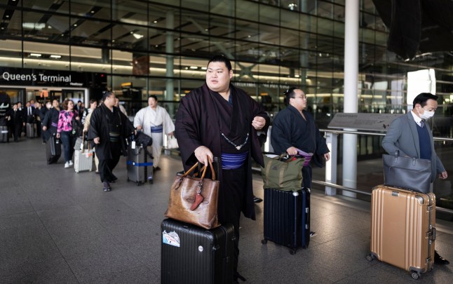 LONDON, ENGLAND - OCTOBER 11: Onosato arrives at Heathrow Airport during previews to the Grand Sumo Tournament at on October 11, 2025 in London, England. This will be only the second time in the sport's 1500-year history that an official Basho tournament will take place outside of Japan, following the 1991 event at the Royal Albert Hall that attracted audiences from across Europe to witness the spectacle. The tournament will host the most accomplished and elite sumos, including those who have reached the top rank of Yokozuna, and showcase Japan's rich cultural history and traditions. (Photo by Ryan Pierse/Getty Images)