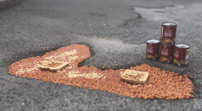 Story From Jam Press (Baked Beans Potholes) Pictured: A grab from a video captured by Ben Thornbury showing the beans on toast pothole he has created. Full of beans! Giant pothole turned into massive bowl of beans on toast to highlight problem A giant pothole was turned into a massive bowl of beans on toast to highlight the problem. Campaigner Ben Thornbury tucked into the traditional English meal to slam the increasingly traditional English problem. He used two slices of toast and 30 tins of baked beans, then added cheese on top. ?I guess you could say this has bean a success,? joked Ben. ?Thank God I get discount from the shop as I would have able to feed my whole family with that amount of beans.? Ben did it in Michael Pyms Road, in his home town of Malmesbury, near Swindon, Wilts. He has set up a Government petition demanding the Government do more to fill them in. ?I decided to do something a little out of the ordinary to draw attention to an issue that affects us all,? Ben, 20, also told What?s The Jam. ?The terrible state of our roads. ?I placed baked beans into a pothole as a creative and eye-catching way to raise awareness. And promote the launch of a new Government petition calling for urgent road repairs and real action to be taken. ?It didn?t take long for people passing by to notice. ?Many stopped to show their support, offering kind words, giving me a thumbs-up, and saying what a great idea it was.? He added about the stunt he did last Friday (10 Oct): ?It was encouraging to see so many members of the community agree that something needs to be done. ?This light-hearted gesture had a serious message behind it. ?It?s time for our local and national authorities to take responsibility and fix the roads properly once and for all. Local Tony Rudall joked: ?Bean and done it again.? Bob Newnham added: ?Nice one Ben.? Kate Almond quipped: ?Yuck.? In August, Ben turned potholes into St George?s Crosses. He has previously turned some into a pitch-and-putt course. Ben's petition -?https://petition.parliament.uk/petitions/739014 - has over 100 backers. ENDS EDITOR'S NOTE:?Video Usage Licence: (EXCLUSIVE) We have obtained an exclusive licence from the copyright holder. A copy of the licence is available on request. Video Restrictions: None.