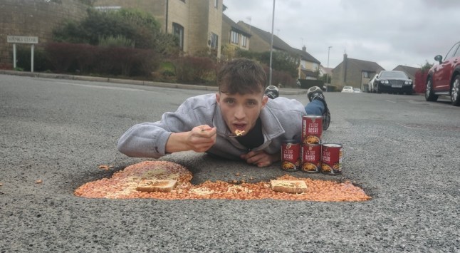 Story From Jam Press (Baked Beans Potholes) Pictured: A grab from a video captured by Ben Thornbury showing him eating from the beans on toast pothole he has created. Full of beans! Giant pothole turned into massive bowl of beans on toast to highlight problem A giant pothole was turned into a massive bowl of beans on toast to highlight the problem. Campaigner Ben Thornbury tucked into the traditional English meal to slam the increasingly traditional English problem. He used two slices of toast and 30 tins of baked beans, then added cheese on top. ?I guess you could say this has bean a success,? joked Ben. ?Thank God I get discount from the shop as I would have able to feed my whole family with that amount of beans.? Ben did it in Michael Pyms Road, in his home town of Malmesbury, near Swindon, Wilts. He has set up a Government petition demanding the Government do more to fill them in. ?I decided to do something a little out of the ordinary to draw attention to an issue that affects us all,? Ben, 20, also told What?s The Jam. ?The terrible state of our roads. ?I placed baked beans into a pothole as a creative and eye-catching way to raise awareness. And promote the launch of a new Government petition calling for urgent road repairs and real action to be taken. ?It didn?t take long for people passing by to notice. ?Many stopped to show their support, offering kind words, giving me a thumbs-up, and saying what a great idea it was.? He added about the stunt he did last Friday (10 Oct): ?It was encouraging to see so many members of the community agree that something needs to be done. ?This light-hearted gesture had a serious message behind it. ?It?s time for our local and national authorities to take responsibility and fix the roads properly once and for all. Local Tony Rudall joked: ?Bean and done it again.? Bob Newnham added: ?Nice one Ben.? Kate Almond quipped: ?Yuck.? In August, Ben turned potholes into St George?s Crosses. He has previously turned some into a pitch-and-putt course. Ben's petition -?https://petition.parliament.uk/petitions/739014 - has over 100 backers. ENDS EDITOR'S NOTE:?Video Usage Licence: (EXCLUSIVE) We have obtained an exclusive licence from the copyright holder. A copy of the licence is available on request. Video Restrictions: None.