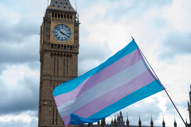 LONDON, UNITED KINGDOM - 2025/07/26: A transgender flag flies front of the Big Ben during the Trans Pride march. Transgender activists, allies, and supporters gathered for the annual Trans Pride march, which took them from the BBC Broadcasting House to Parliament Square in London. (Photo by Krisztian Elek/SOPA Images/LightRocket via Getty Images)