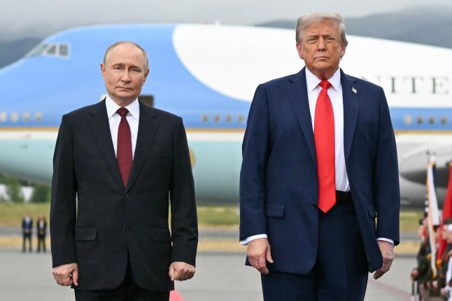 US President Donald Trump and Vladimir Putin standing in front of a plane in Alaska.