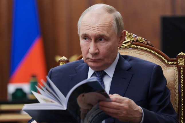 Russian President Vladimir Putin listens to the head of the Federal Service for Supervision of Natural Resources (Rosprirodnadzor) Svetlana Radionova during their meeting at the Kremlin in Moscow, Russia, on Tuesday, Oct. 21, 2025. (Alexander Kazakov, Sputnik, Kremlin Pool Photo via AP)