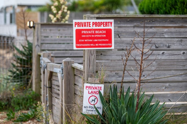 BNPS.co.uk (01202 558833) Pic: BNPS Pictured: Private beach signs. Get orf my beach.. Sandbanks residents have instructed lawyers to take legal action after a 'public' beach behind a row of multi-million mansions was fenced off in an apparent 'land-grab'. For decades people have enjoyed unrestricted access to the sandy foreshore on the northern side of the exclusive peninsula in Poole Harbour, Dorset. It is a favourite spot for dog walkers, sea swimmers and paddlers and for those taking in a sunset stroll.