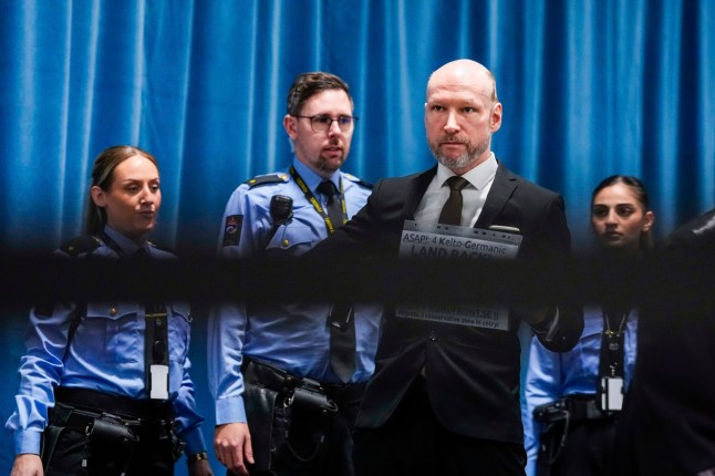 Anders Behring Breivik arrives at the courtroom for day one of the Ringerike, Asker and B??rum district court's processing of Fjotolf Hansen's petition for parole, in Tyristrand, Norway, Tuesday, Nov. 19, 2024. (Beate Oma Dahle/NTB Scanpix via AP)