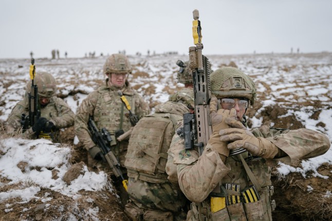 SMARDAN, ROMANIA - FEBRUARY 17: A British soldier reloads his gun on February 17, 2025 in Smardan, Romania. The UK's 1st Division is commanding land forces during Exercise Steadfast Dart, as NATO Allied Reaction Force (ARF) training continues in Romania. The ARF was established in July 2024 amid a restructuring of the Alliance's high-readiness forces, with the capability of rapidly reinforcing NATO's eastern flank. The exercise includes 10,000 service personnel from nine nations, carried out across Romania, Greece, and Bulgaria during January and February. Steadfast Dart marks the first full-scale operational deployment of ARF, and this week coincides with the third anniversary of Russia's large-scale invasion of Ukraine in 2022. (Photo by Andrei Pungovschi/Getty Images) *** BESTPIX ***