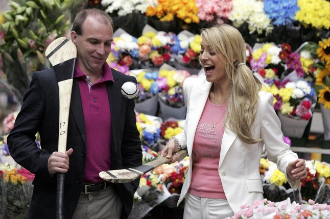 TV presenter Tess Daly tries her hand at Ireland's national game of hurling, with Kilkenny Hurling Legend DJ Carey (left), in Moore Street.