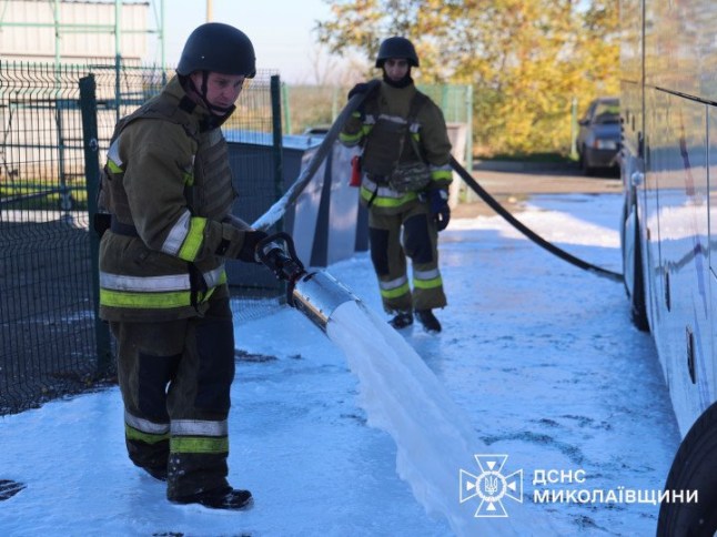Photo of Ukrainian emergency responders use foam to neutralise spilled fuel after a Russian missile strike on Mykolaiv.