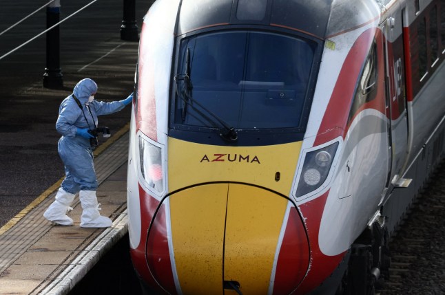A forensic officer inspects the London North Eastern Railway (LNER) train where a series of stabbings took place, at a platform at Huntingdon Station, near Cambridge