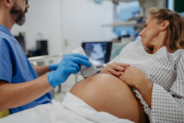Ob/gyn doctor doing ultrasound of baby on pregnant woman. Woman having sonogram. Prenatal visit or care during third trimester of pregnancy. Pregnant woman on pregnancy check-up in gynaecologist doctor???s office.
