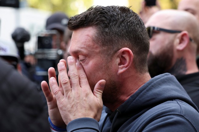 Anti-immigration activist Stephen Yaxley-Lennon, known as Tommy Robinson, charged with an offence under the Terrorism Act for failing to give the PIN to his mobile phone to police, reacts outside Westminster Magistrates' Court in London, Britain, November 4, 2025. REUTERS/Isabel Infantes