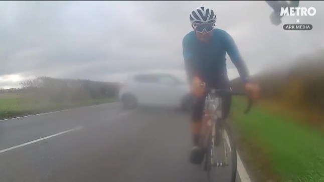 A cyclist narrowly avoided being directly hit by an oncoming car that skidded out of control. The footage was captured by George Fox while cycling in Northamptonshire on November 6th. George recalls the car came around a bend sideways and started to skid. As the car skidded across the road, it avoided George and his fellow cyclist by mere inches.