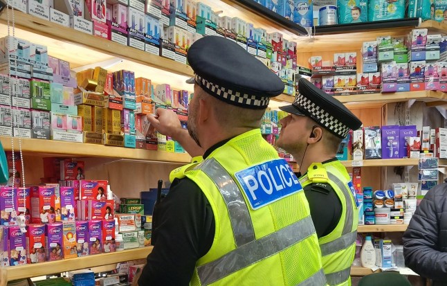 EMBARGOED TO 0001 TUESDAY NOVEMBER 11 Undated handout photo issued by National Crime Agency (NCA) of police officers looking at vapes. More than 2,700 high street businesses including barbers, minimarts and vape shops have been raided in the biggest ever crackdown of its kind on money-laundering. Issue date: Tuesday November 11, 2025. PA Photo. Photo credit should read: NCA/PA Wire NOTE TO EDITORS: This handout photo may only be used for editorial reporting purposes for the contemporaneous illustration of events, things or the people in the image or facts mentioned in the caption. Reuse of the picture may require further permission from the copyright holder.