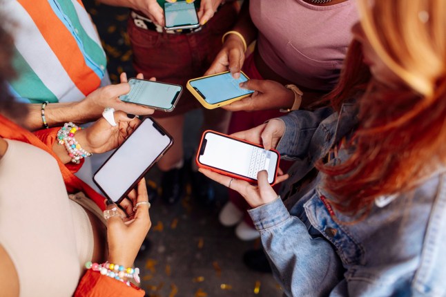 A multicultural group of Gen Z individuals holding smartphones; They showcase vibrant attire and accessories, symbolizing diversity and modern connectivity