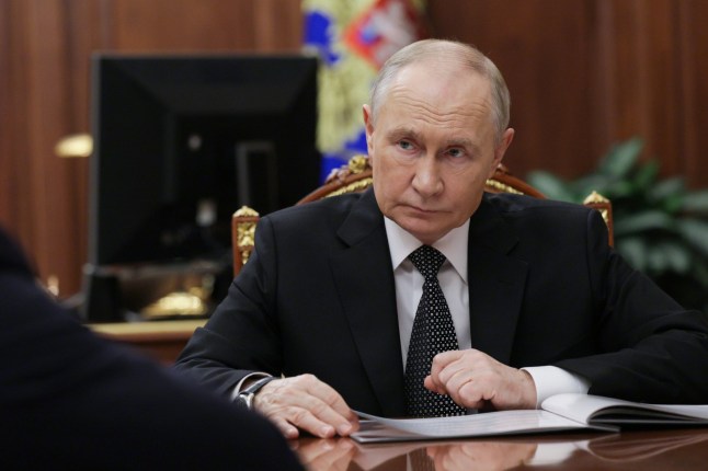 Russian President Vladimir Putin listens to Astrakhan Region Governor Igor Babushkin at the Kremlin in Moscow, Russia, Thursday, Nov. 13, 2025. (Gavriil Grigorov/Sputnik, Kremlin Pool Photo via AP)