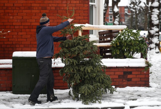 Mandatory Credit: Photo by ADAM VAUGHAN/EPA-EFE/Shutterstock (15073775n) A resident carries a Christmas tree on a snow-covered sidewalk in Liverpool, Britain, 05 January 2025. The Met Office has issued a yellow warning for snow and ice across nearly all of Britain, with a more severe amber snow warning in place throughout much of northern Britain and Wales. Heavy snow in Liverpool amidst warnings for snow and ice across Britain, United Kingdom - 05 Jan 2025