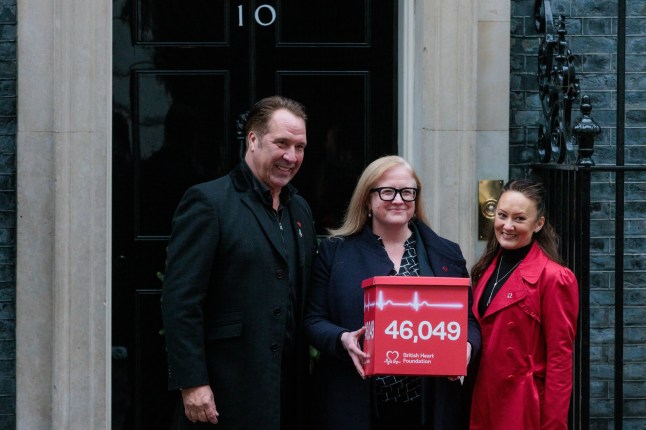 British Heart Foundation Chief Executive Dr Charmaine Griffiths (c) and ambassadors David and Frankie Seaman deliver a pledge to 10 Downing Street signed by 46,049 people calling on the UK government to make tackling cardiovascular disease a priority as part of British Heart Foundation's Hearts Need More campaign on 4th December 2024 in London, United Kingdom. (photo by Mark Kerrison/In Pictures via Getty Images)
