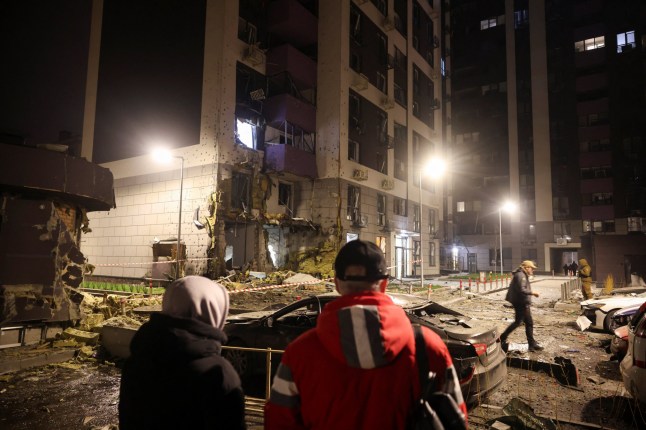 People look at the site of an apartment building that was hit during a Russian missile and drone attack on Kyiv, amid Russia's attack on Ukraine, November 29, 2025. REUTERS/Thomas Peter