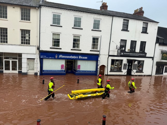 Rescue workers wade through floodwater after severe flooding in south Wales, as Storm Claudia reaches parts of the United Kingdom, in Monmouth, Wales, Britain, November 15, 2025 in this picture obtained from social media. Kim Kaos/via REUTERS THIS IMAGE HAS BEEN SUPPLIED BY A THIRD PARTY. MANDATORY CREDIT. NO RESALES. NO ARCHIVES. VERIFICATION: Reuters was able to verify the location from the design of the buildings, position of the road and shop signs which matched file and satellite imagery of the area. That was confirmed from the original file metadata.