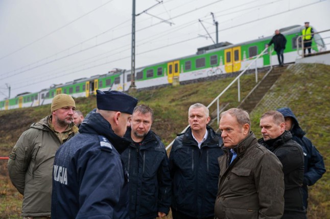 WARSAW, POLAND - NOVEMBER 17: (----EDITORIAL USE ONLY - MANDATORY CREDIT - THE CHANCELLERY OF THE PRIME MINISTER OF POLAND (KPRM) /X ACCOUNT/ HANDOUT' - NO MARKETING NO ADVERTISING CAMPAIGNS - DISTRIBUTED AS A SERVICE TO CLIENTS----) Poland Prime Minister Donald Tusk and Polish Interior Minister Marcin Kierwinski inspect the damaged railway tracks on the Warsaw-Lublin route in Poland on November 17, 2025. Damage caused overnight on the intercity Warsaw-Lublin rail line near the village of Mika was an act of sabotage, Polish Prime Minister Donald Tusk posted on US social media company X on Monday. (Photo by KPRM/XAccount/Anadolu via Getty Images)