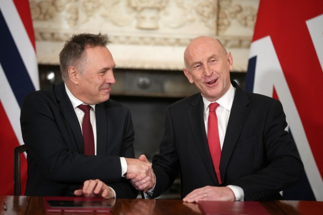 Norway's Minister of Defence Tore O. Sandvik, left, and Britain's Secretary of State for Defence John Healey shake hands during the signing of a Strategic Defence Agreement in Downing Street in London, Thursday, Dec. 4, 2025. (AP Photo/Alastair Grant, pool)