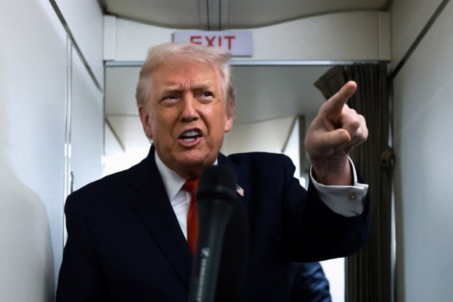 U.S. President Donald Trump points his finger as he speaks to reporters aboard Air Force One during travel to Pennsylvania from Joint Base Andrews, Maryland, U.S. December 9, 2025. REUTERS/Jonathan Ernst